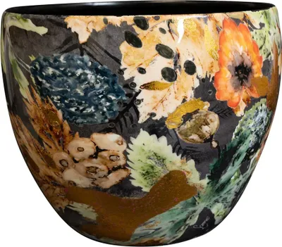 A close-up, detailed view of a decorative ceramic bowl with a dark background and a vibrant, botanical-inspired pattern.