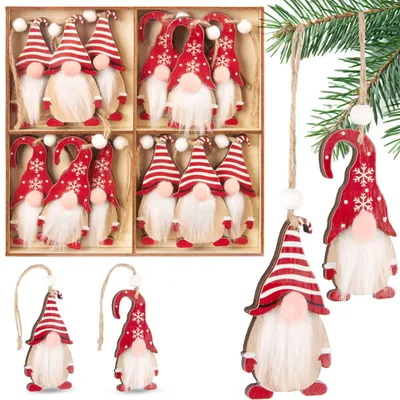 A collection of Christmas gnome ornaments in a wooden box and hanging from a tree branch.