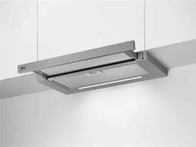 A modern kitchen range hood installed under a cabinet.