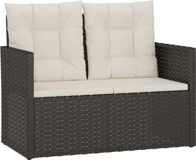 A studio shot of a black poly rattan garden bench with white cushions.
