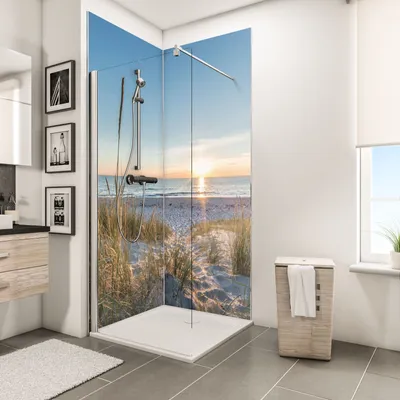 A modern bathroom with a corner shower featuring a scenic beach sunset print on the glass panels.