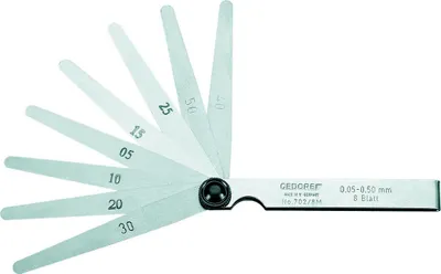A set of feeler gauges fanned out.