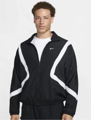A man wearing a black Nike jacket with white accents.
