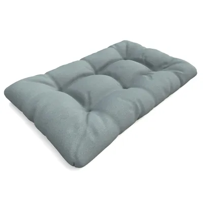 A light blue tufted cushion is shown from a diagonal angle against a white background.
