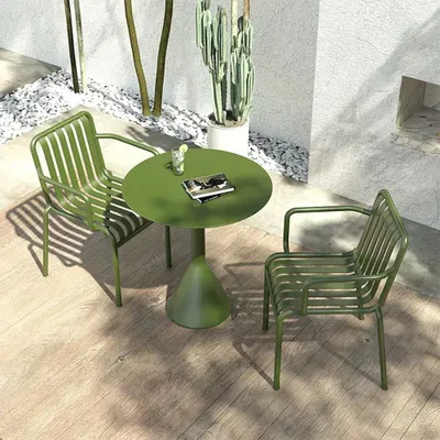 An outdoor patio scene with a green metal table and chairs set.