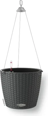 A hanging planter basket with a woven texture, suspended by wires from a ceiling mount. A water level indicator is visible inside the basket.