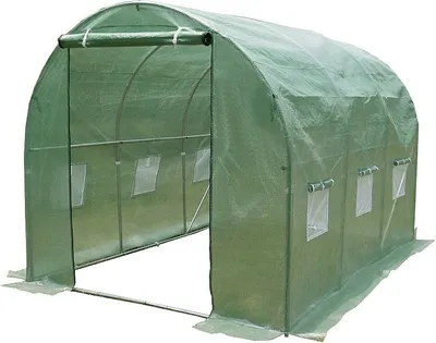 A green greenhouse tunnel with a metal frame and transparent plastic sheeting.