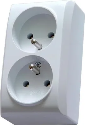 A white double electrical socket with grounding pins.