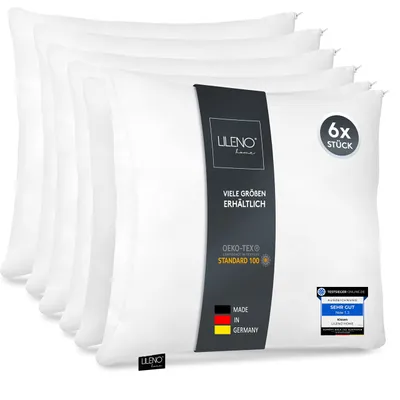 A stack of white pillows with a product label.