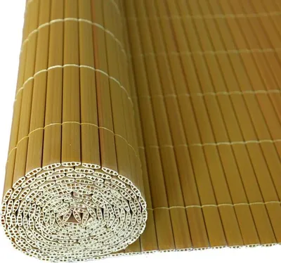 A rolled-up bamboo mat, likely for privacy screening, is shown against a white background.