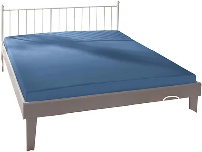 A blue fitted sheet on a bed frame with a white headboard.
