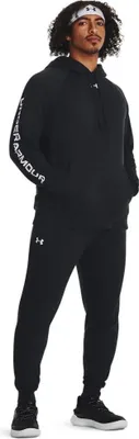 A man wearing a black Under Armour tracksuit.