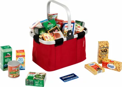 A red shopping basket filled with various grocery items, along with some items placed around it on a white background.