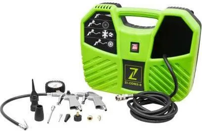 A green and black portable air compressor kit with various accessories, including a tire pressure gauge, air nozzles, and two air guns, laid out on a white background.