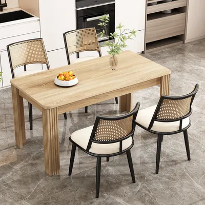 A dining table with four chairs in a modern kitchen setting.