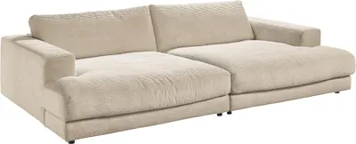 A cream-colored corduroy sofa is shown from a diagonal angle against a white background.