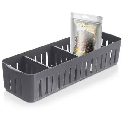 A gray plastic organizer with multiple compartments, containing a small bag of black peppercorns.