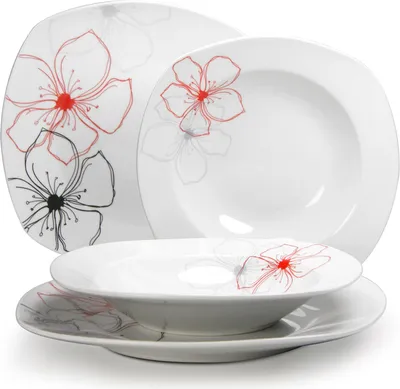 A set of white ceramic plates and bowls with a floral pattern.