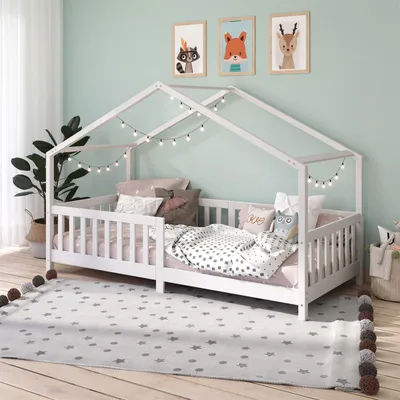 A child's bedroom with a house-shaped bed.