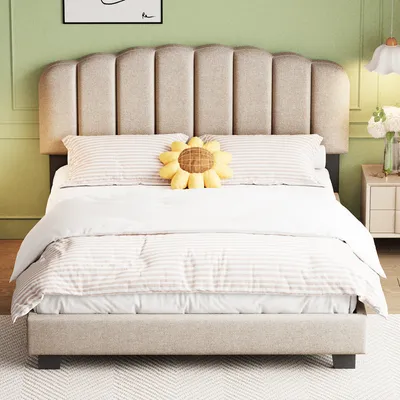 A bed with bedding and a decorative pillow in a room.