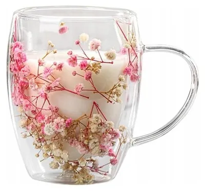 A clear glass mug filled with dried flowers.