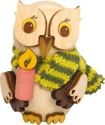 A wooden owl figurine holding a candle and wearing a scarf.