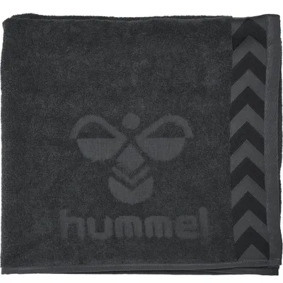 A dark gray towel with the Hummel logo and brand name embossed on it.