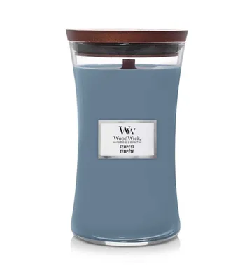 A WoodWick candle with a blue wax and a wooden lid.
