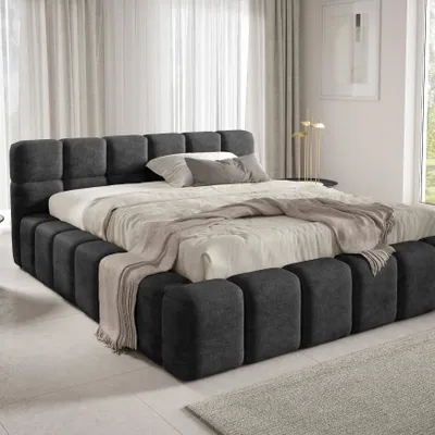 A modern bedroom with a large upholstered bed.