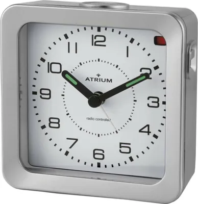 A close-up studio shot of a silver alarm clock with a white face.