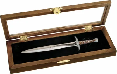 A letter opener shaped like a sword is displayed in a wooden box with a glass lid.