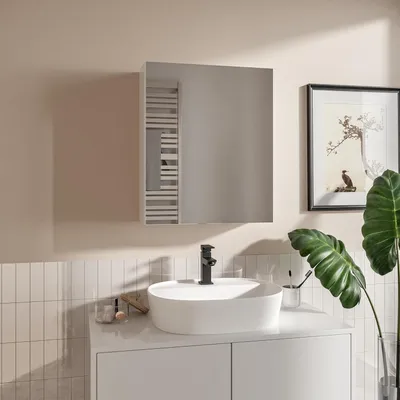 A modern bathroom vanity with a sink, faucet, and a mirror cabinet.