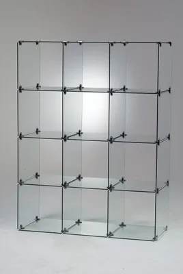 A clear, studio shot of a glass display shelf unit.