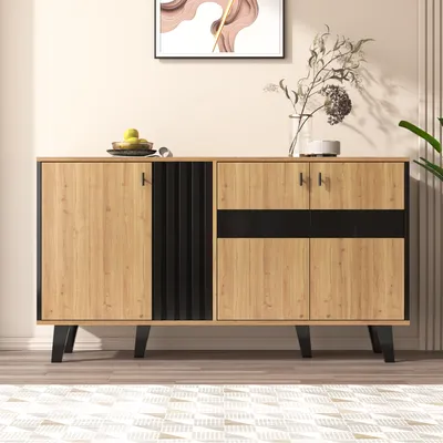 A wooden sideboard with black accents is displayed in a room with a painting on the wall and a plant in the background.