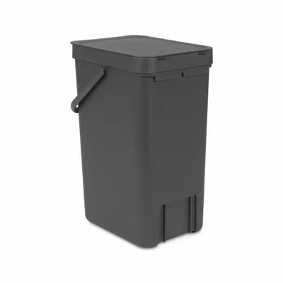 A dark gray trash bin with a lid and handle, shown from a three-quarter angle against a white background.