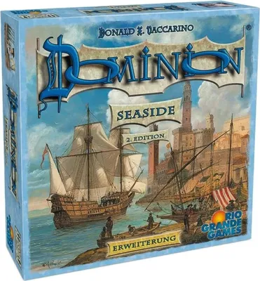 The image shows the box art for the Dominion: Seaside board game expansion, featuring a harbor scene with sailing ships and buildings.