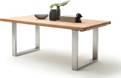 A wooden dining table with metal legs, shown from a slight angle against a white background.