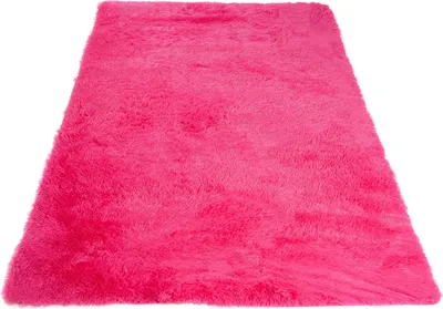 A fluffy pink rug is shown from a slightly elevated angle against a white background.