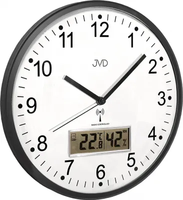 A close-up shot of a wall clock with a digital display showing temperature and humidity.
