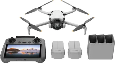 A drone and its accessories are laid out on a white background.