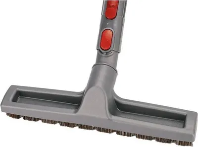 A close-up shot of a vacuum cleaner attachment with bristles.