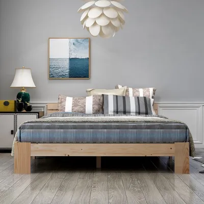 A bedroom scene with a bed, nightstand, and artwork.