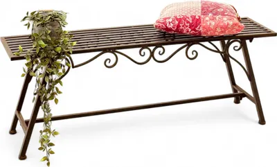 A metal garden bench with a potted plant and a cushion.