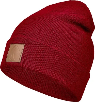 A close-up studio shot of a red beanie with a brown leather patch.