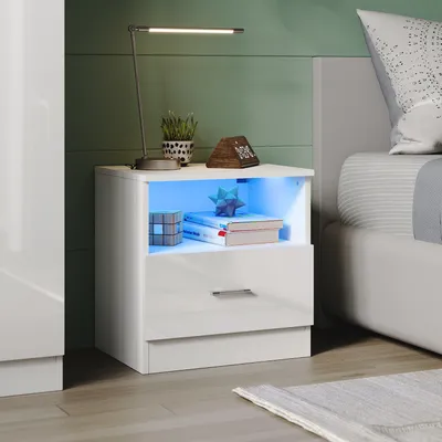 A modern bedroom scene with a white nightstand featuring LED lighting.