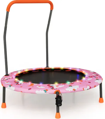 A child's mini trampoline with a pink unicorn and cloud pattern, featuring LED lights around the edge and a removable handle.