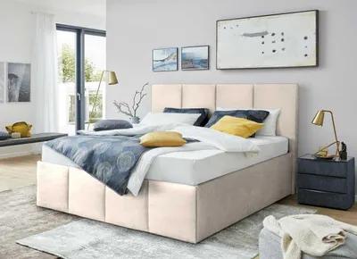 A bedroom scene with a bed, nightstand, and artwork.