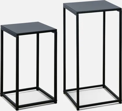 Two black metal side tables of different heights against a white background.