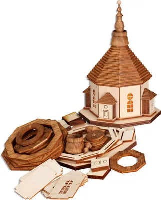 A wooden model church kit and its components are laid out on a white background.