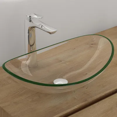 A glass vessel sink with a chrome faucet on a wooden countertop.